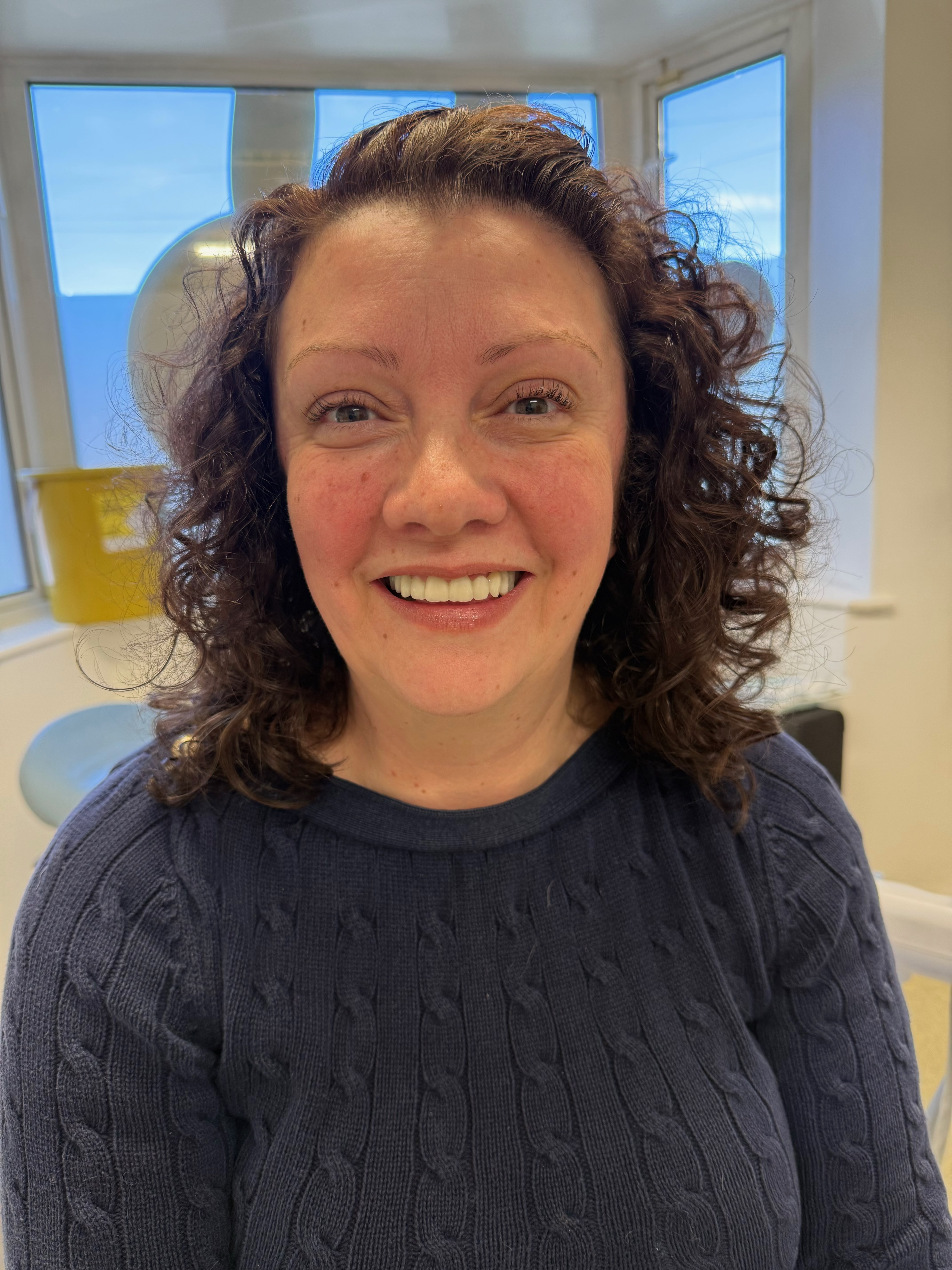 Patient smiling after dental implant treatment at Pure Implant Health